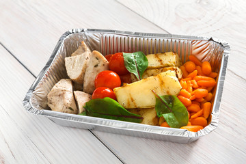 Healthy food in boxes, diet concept. Steamed turkey with vegetables