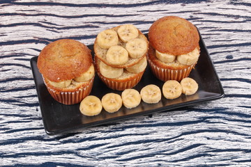 Homemade banana cakes topped sliced banana.