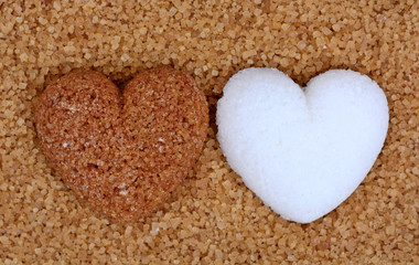 Beige sugar heart with white sugar heart on sugar background