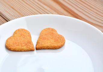 Two shortbread hearts on a white plate for a special day