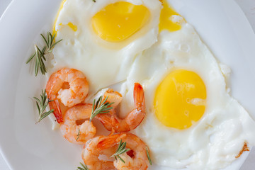 Fried eggs with shrimps top view