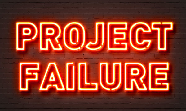 Project failure neon sign on brick wall background.
