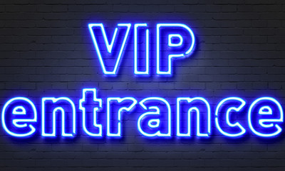 VIP entrance neon sign on brick wall background.