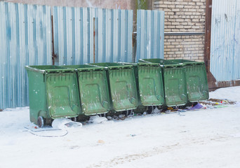 in winter, garbage cans, plastic, green on the street.