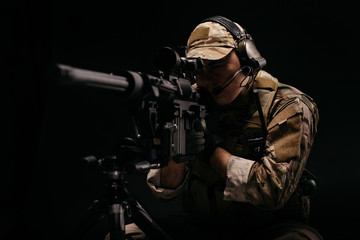 Fototapeta premium Portrait soldier or private military contractor holding sniper rifle.