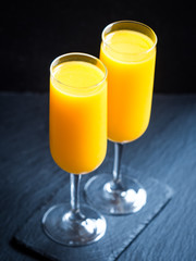 Freshly squeezed orange juice in champagne glasses