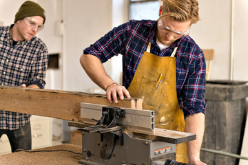 Mid adult men working in carpentry workshop