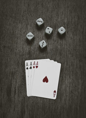 four aces playing cards and dice
