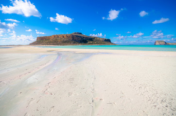 Amazing panorama of Balos Lagoon with magical turquoise waters, lagoons, tropical beaches of pure white sand and Gramvousa island on Crete, Greece