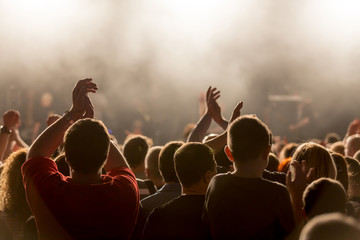 Crowd people with hands in the air at a music festival