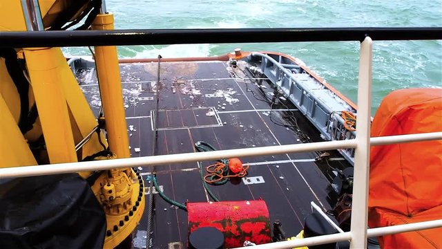 Tug sets anchor and red buoy pipe layer platform