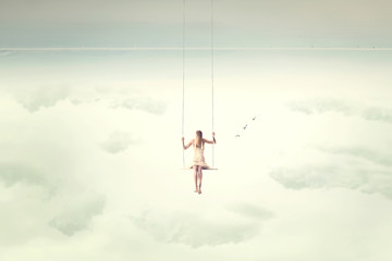 upside down surrealistic minimal woman swings in the air
