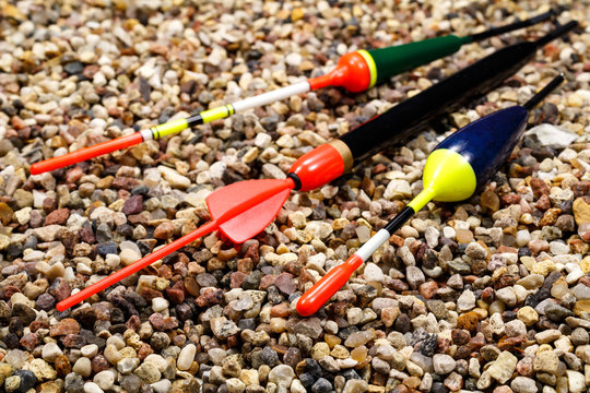 Collection of fishing floats on the stony ground