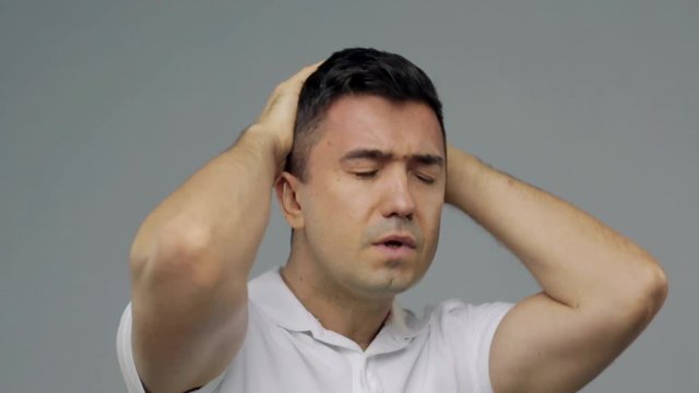unhappy man suffering from head ache