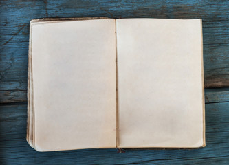 open blank pages of old book on wood background