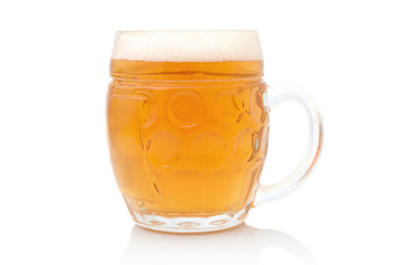 Lager in typical glass with froth on top. Isolated on white background with shadow reflection. Ale in mug with froth. Half a liter of beer in glass. Ale in bock. Glass of beer.