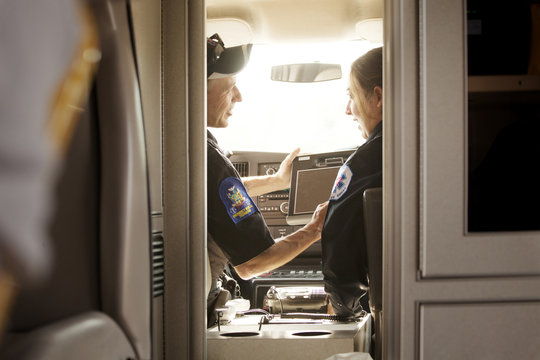 Emergency medical technician talking in ambulance