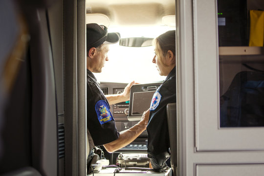 Female and male paramedics in ambulance