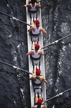 Overhead view of female crew racers rowing  shell boat