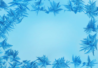 Fototapeta na wymiar Frame from frost pattern, blue background