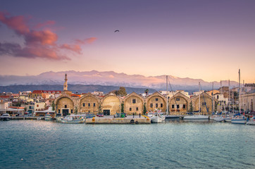 Panorama of the beautiful old harbor of Chania with the amazing lighthouse, at sunset, Crete,...