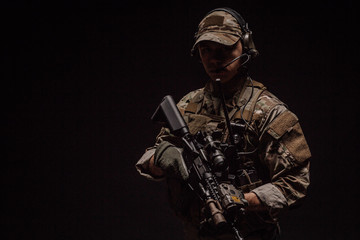 Portrait soldier or private military contractor holding sniper rifle. war, army, weapon, technology...