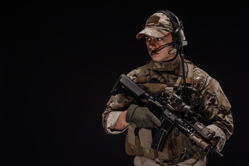 Portrait soldier or private military contractor holding sniper rifle. war, army, weapon, technology...