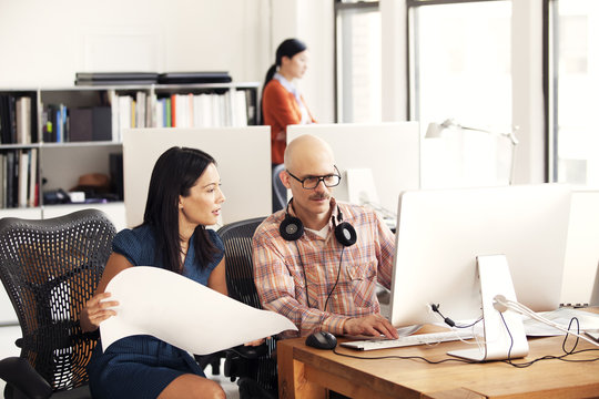 Man And Woman Working On Computer In The Office