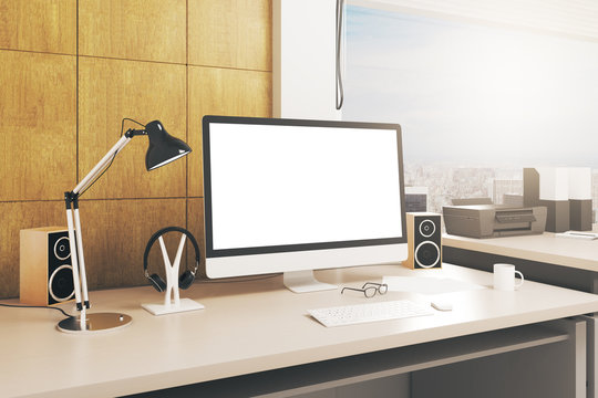 Desk with blank white computer