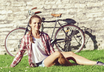 Young, beautiful hipster girl having a rest in a park. Holiday, traveling, concept.