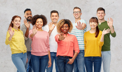 international group of happy people waving hand