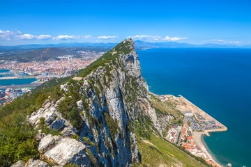 Fotobehang Aerial view of top of Gibraltar Rock, in Upper Rock Natural Reserve: on the left Gibraltar town and bay, La Linea town in Spain at the far end, Mediterranean Sea on the right. United Kingdom, Europe. © bennymarty