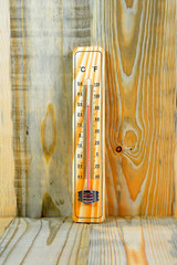 Thermometer on a wooden background