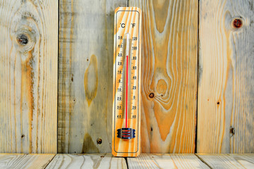Thermometer on a wooden background