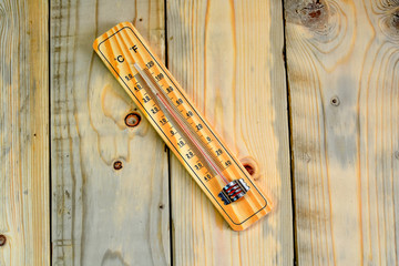 Thermometer on a wooden background