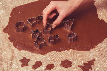 Christmas gingerbread cooking and decoration on the wooden table in the kitchen. Homemade pastries.