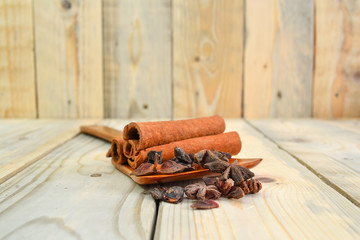 dried cinnamon and star anise close up isolated on wooden background