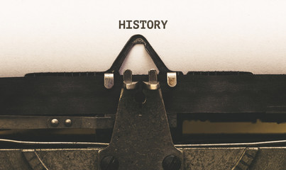 History, Text on paper in vintage type writer from 1920s - obrazy, fototapety, plakaty