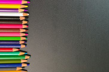 Close up of color pencils over black background