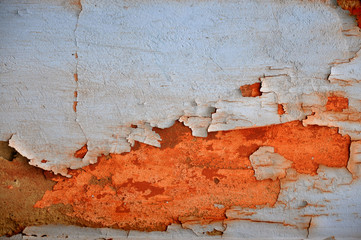 Texture rusty orange metallic surface painted with peeling gray paint.
