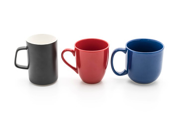 Set of black, red and blue cups on white