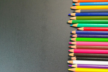 Close up of color pencils over black background