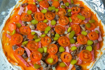 pizza before baking is on the table.