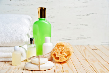Bathroom accessories and white towel. Soap and lotion. Beauty care accessories for bath.