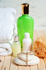 Obraz na płótnie Canvas Bathroom accessories and white towel. Soap and lotion. Beauty care accessories for bath.