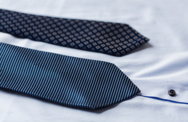 close up of shirt and blue patterned ties