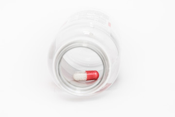 last tablet at the bottom of the bottle,isolated on white background.