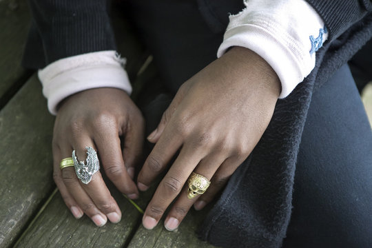 the hands of a black man with rings