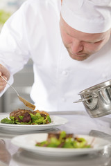 Professional chef prepare meat dish at restaurant