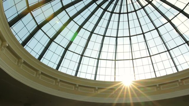 Sun setting outside a glass sky dome.